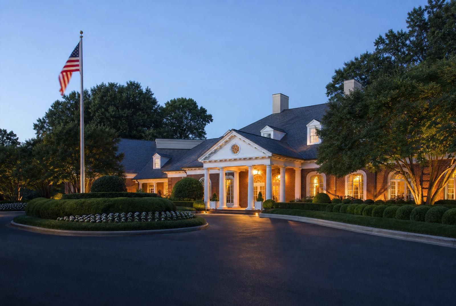 Elegant clubhouse exterior with white columns at dusk